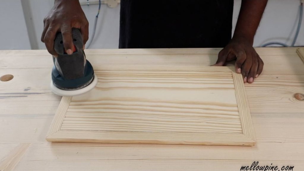 sanding the board after the glue cured