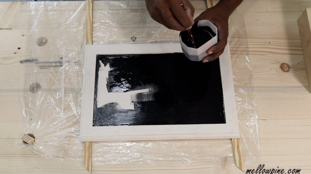 applying chalkboard paint on the tray