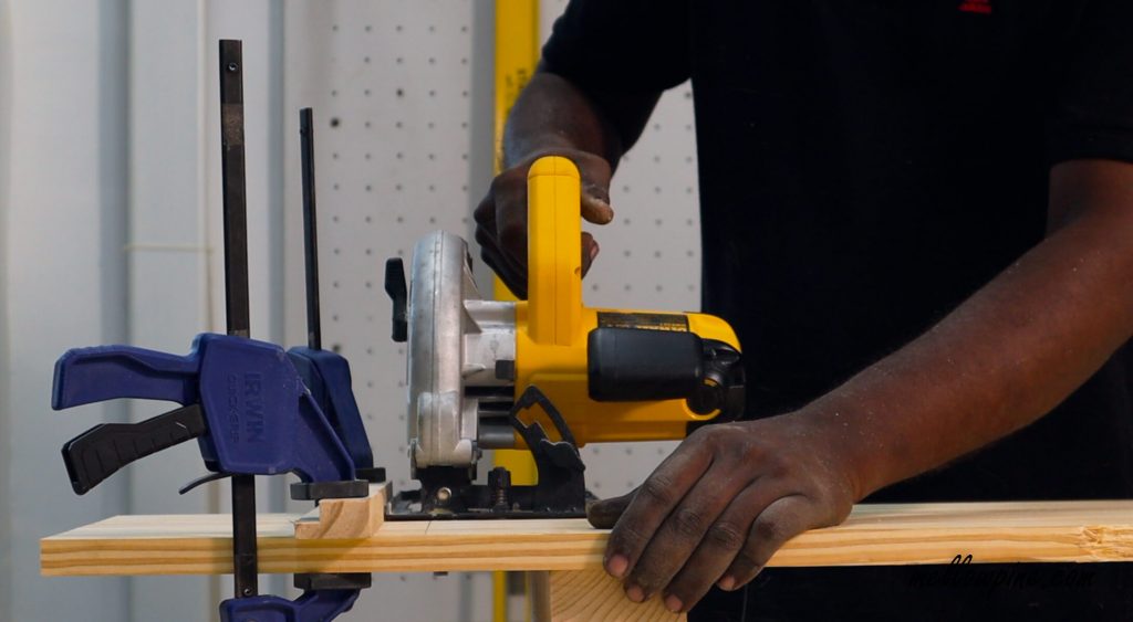 cutting the wood piece from base