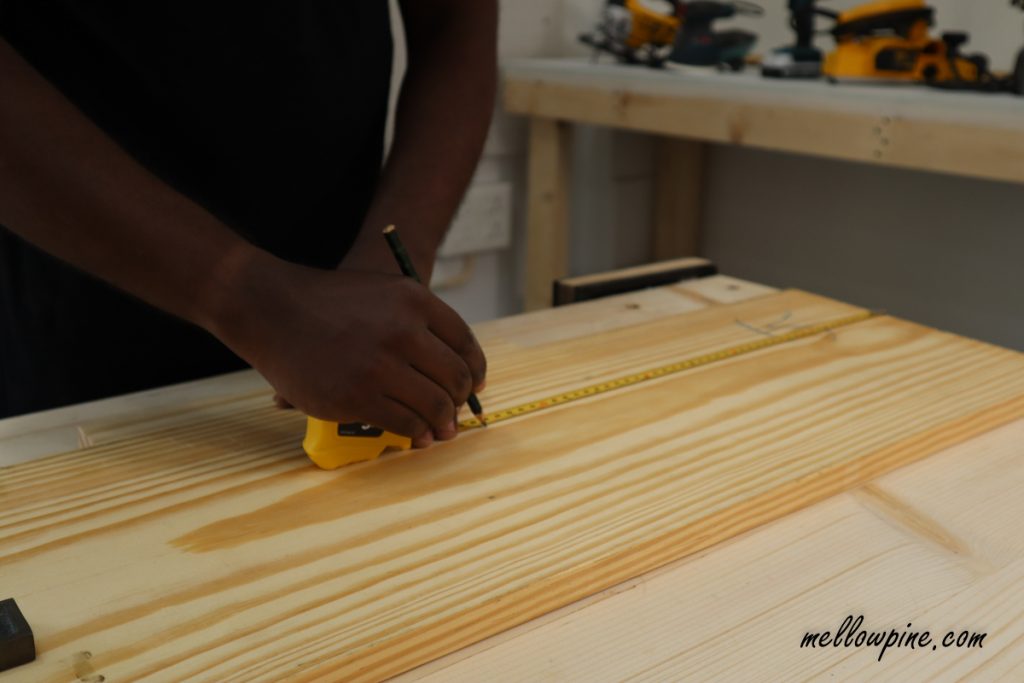 measuring wood using tape