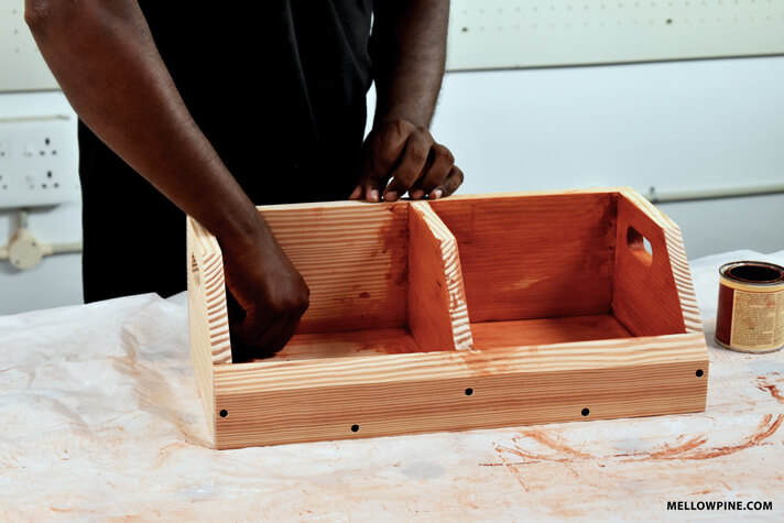 Applying cherry finish to the produce bin