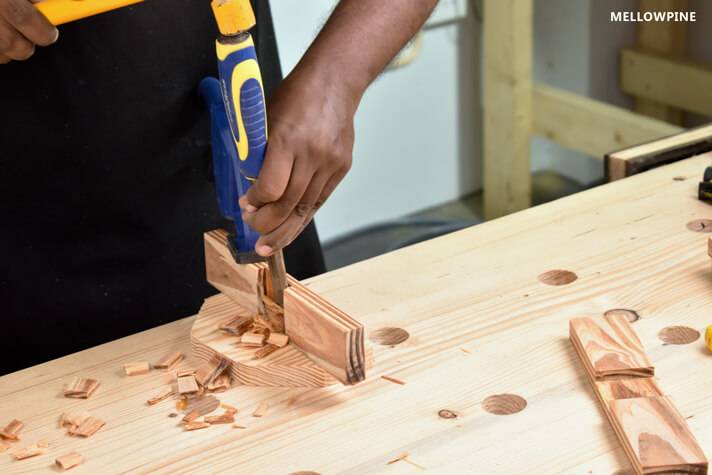 Chiseling the wood out after making multiple cuts