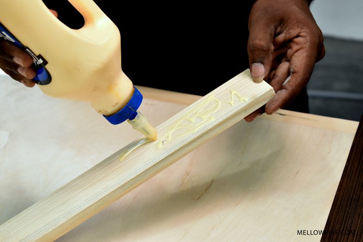 Applying glue on wood piece
