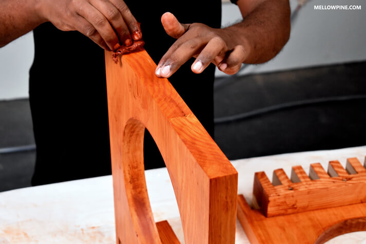 Staining the leg of the bench with cherry stain
