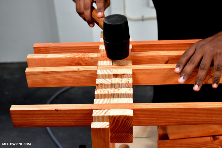Fitting the slats into the box joint in the legs