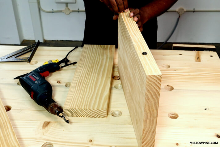Putting on the drill center inside the dowel hole for marking in the other piece