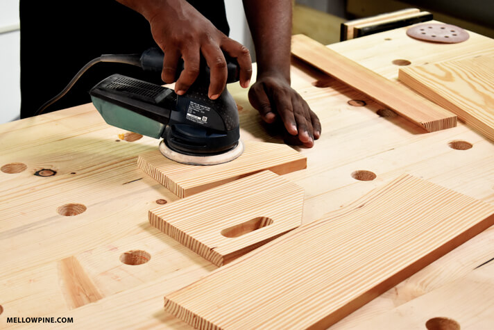 Sanding the pieces for the produce storage bin