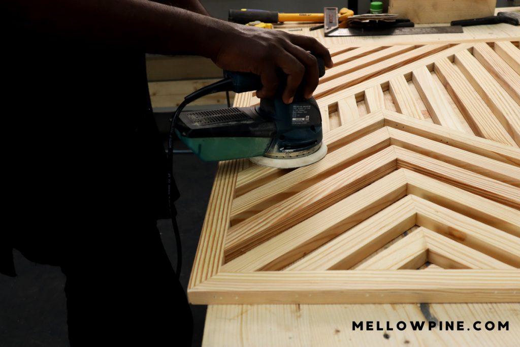 sanding the wall art