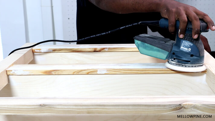 Sanding the wood filler using a sander
