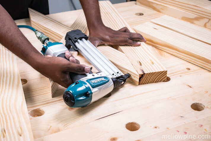 Nailing the vertical piece to the X brace
