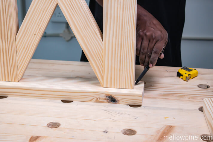 Marking the location to fix the leg frame on the base