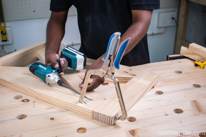 Driving pocket hole screws to join the top horizontal piece to the leg frame