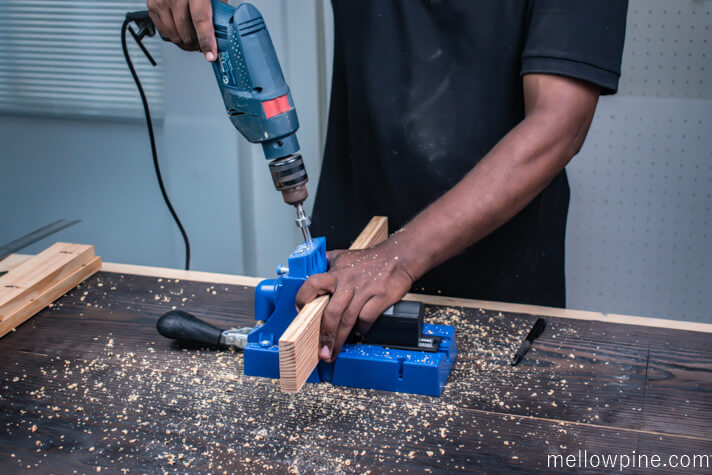 Drilling the pocket holes in the short pieces of the slot frame as per plan
