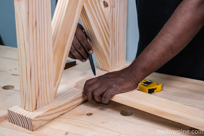 Marking the dovetail slot using the bracing piece as reference.