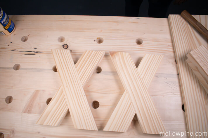 Applying glue and joining the X brace pieces together
