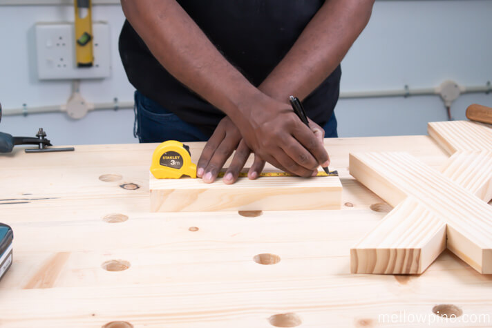 Marking the lines for fixing the X brace to the base piece