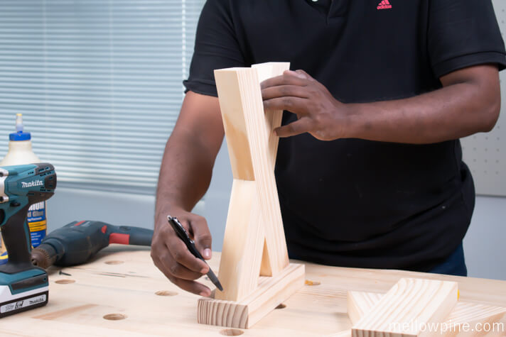 Marking the lines for fixing the X brace to the base piece
