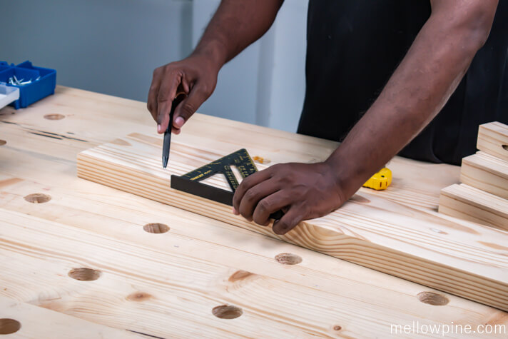 Marking the locations for attaching the bracing pieces to the leg pieces