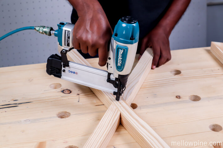Nailing the legs together at the half-lap slot to make the X leg
