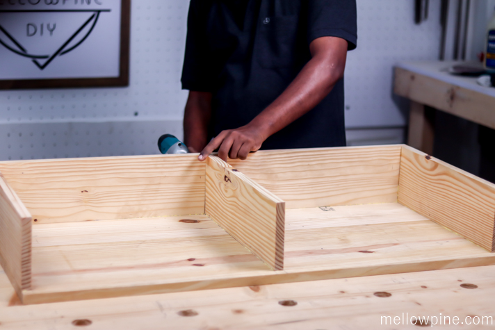 Fixing the back piece and the three partition pieces to the bottom panel