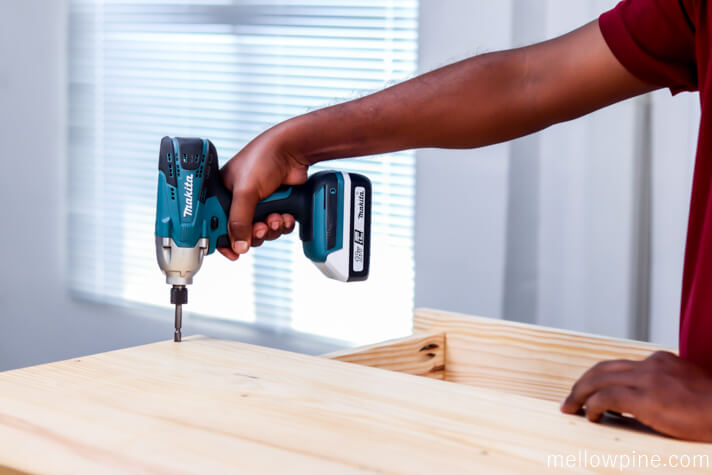 Screwing the top panel to the desk