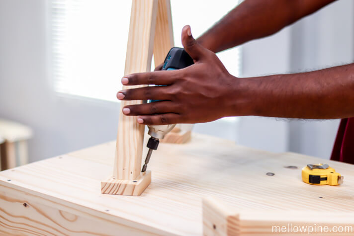 Fixing the X legs to the desk through the end piece