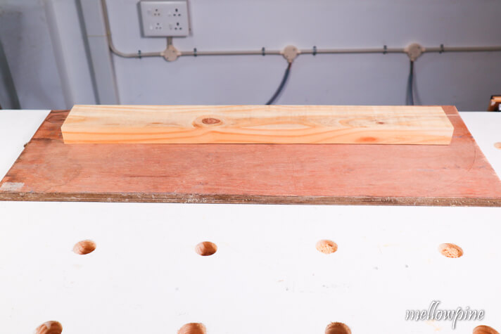 2x4 on top of the sacrificial sheet of plywood
