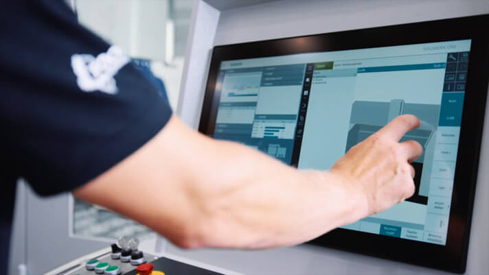 Person operating a CNC control screen
