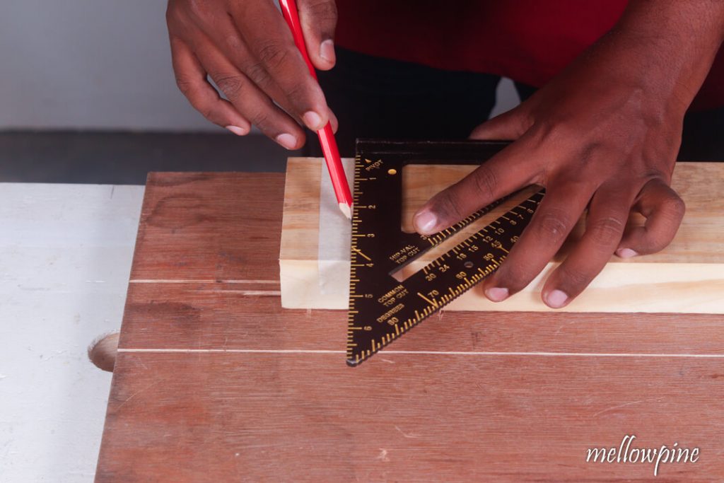 Marking cut line using pencil and speed square