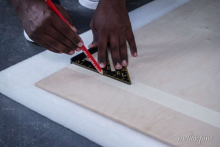 marking the cut line using a speed square and pencil