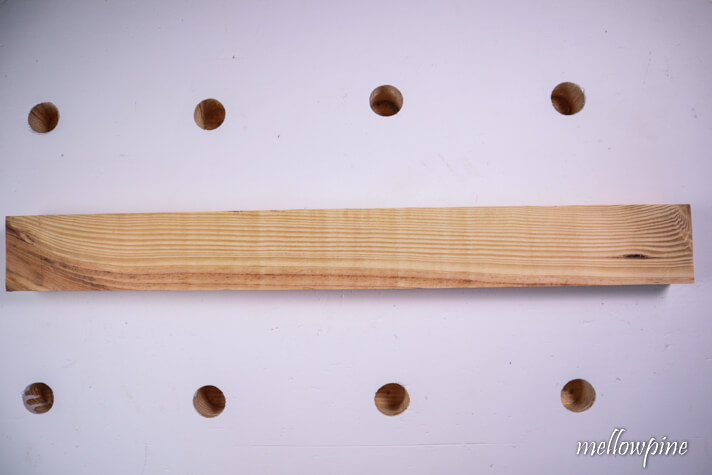 Wood to be cut placed on the work surface.