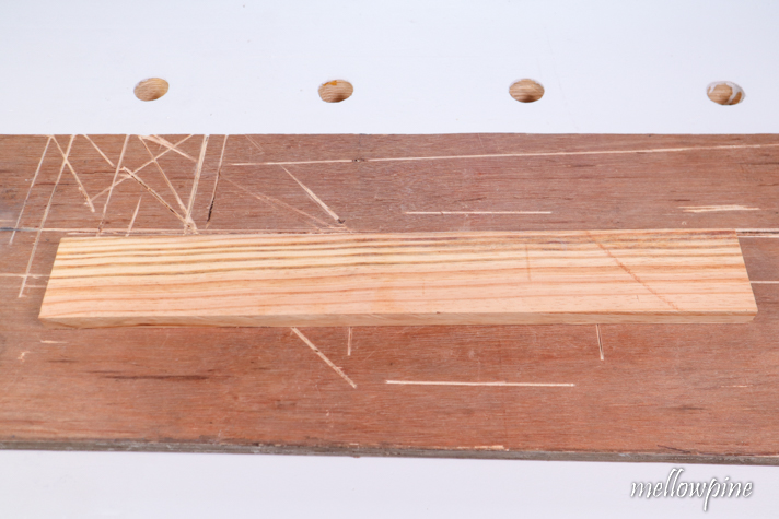 place wood for cutting over sacrificial board