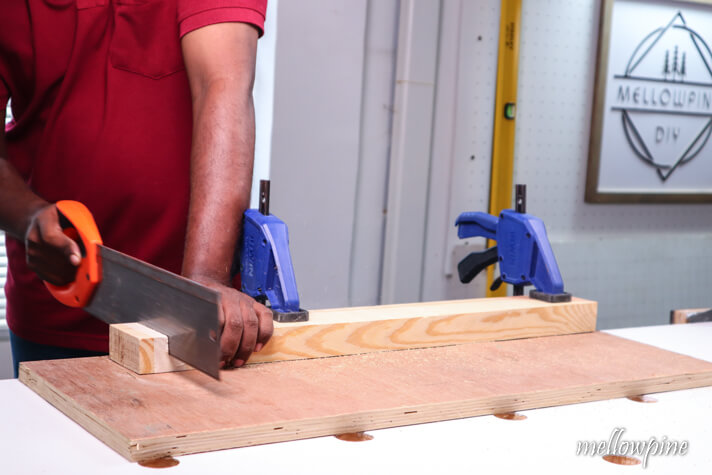 cutting the wood with hand saw