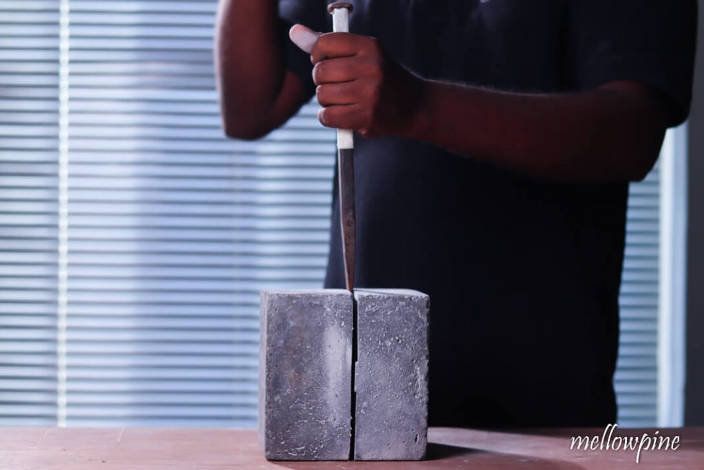 Separating concreate block using hammer and chisel
