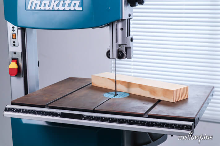 placing the wood on the band saw bed