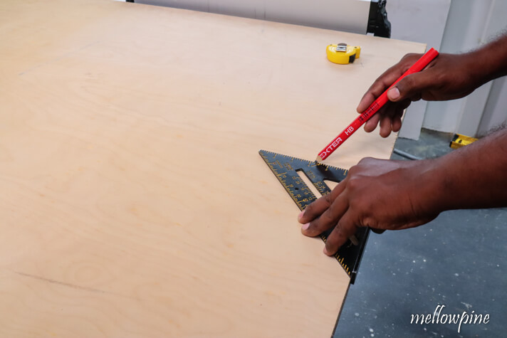 marking the ripping width on the plywood sheet