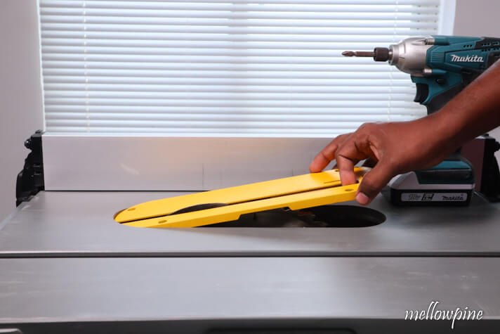 removing the throat plate from the table saw