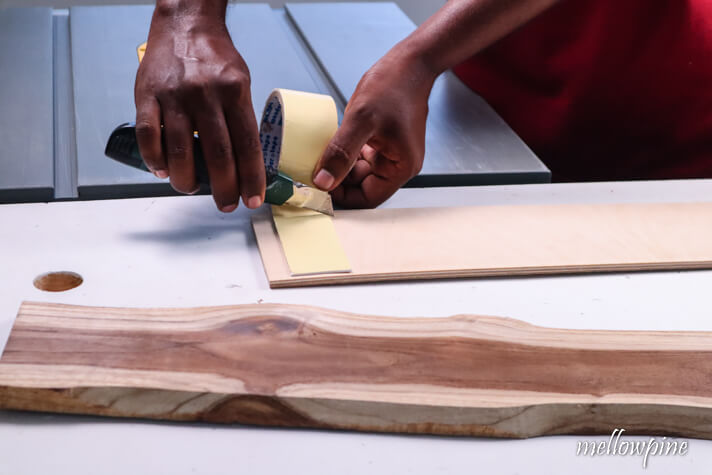 sticking double sided tape on the plywood 