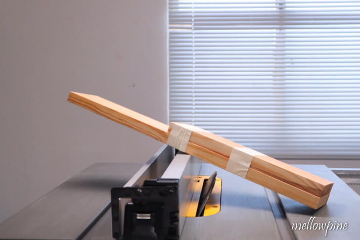 taping the scrap wood and wood to be cut together
