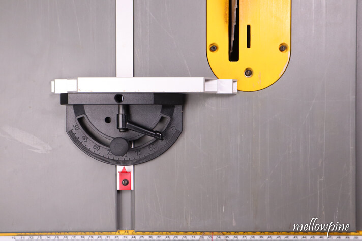 inserting miter gauge into the table saw track