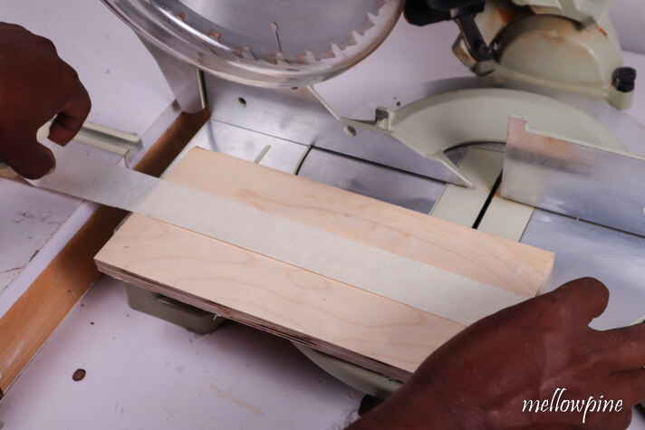 fixing masking tape on the plywood