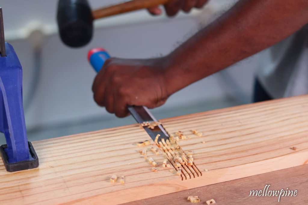 Chiseling away the wood to make the groove
