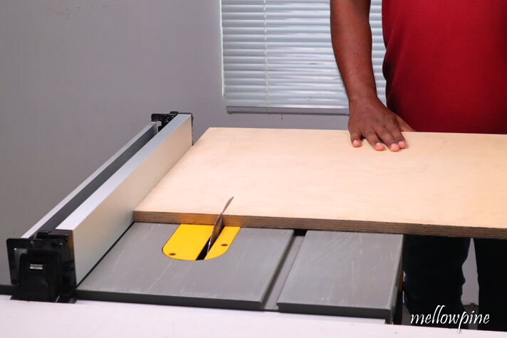cutting the plywood sheet on table saw