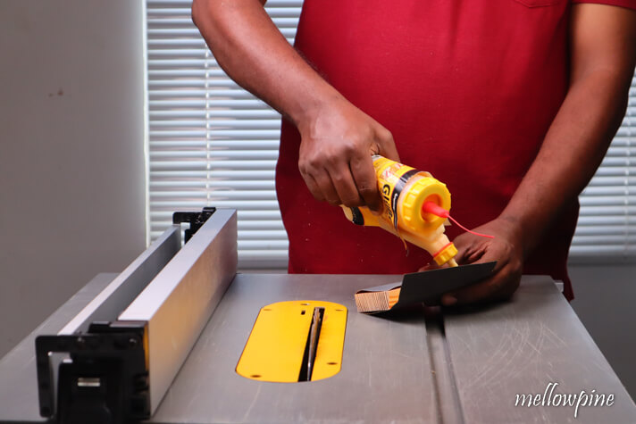 fixing sandpaper on the block of wood