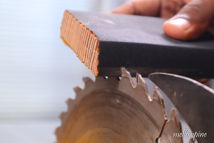 slipping sanding block between the teeth of the saw blade