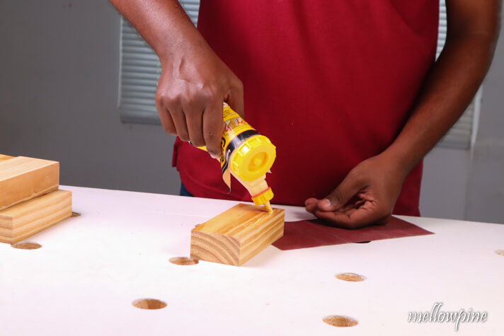 applying glue on sanding block