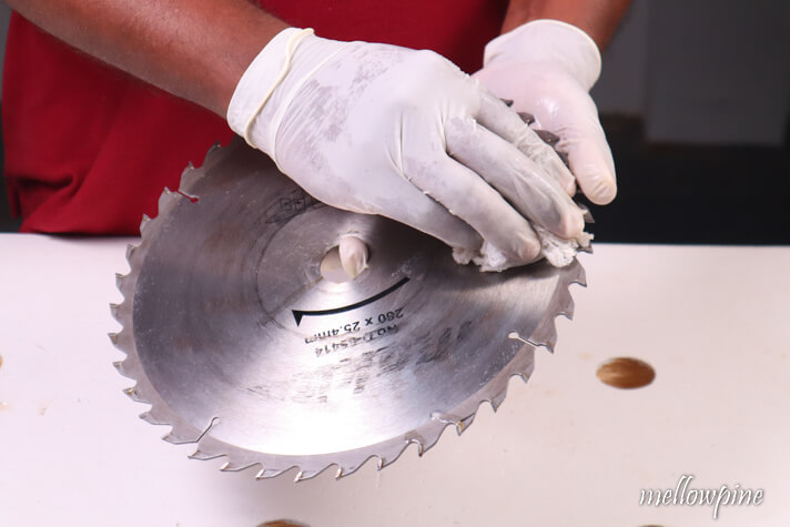 wiping the table saw blade clean 