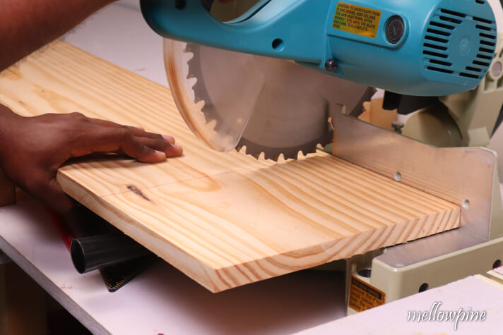 lowering miter saw blade to check if it falls on cut line