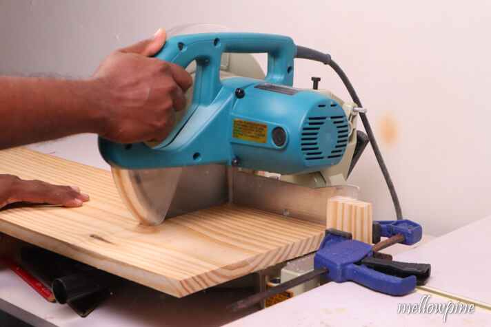 making the first cut on the wide board with miter saw