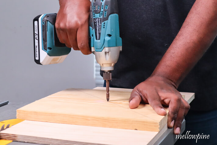 screwing the wooden board to the plywood board on the jig